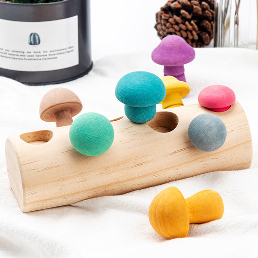 Wooden toy with colorful mushroom-shaped beads on a white surface