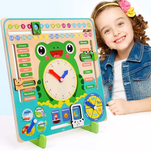 Child holding a colorful educational board with a frog clock and calendar, smiling.