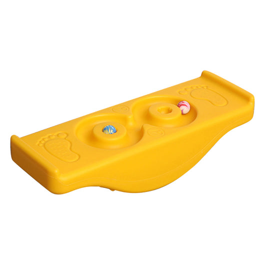 A bright yellow children's balance platform rock and roll seesaw toy with a few holes and small items placed on it.