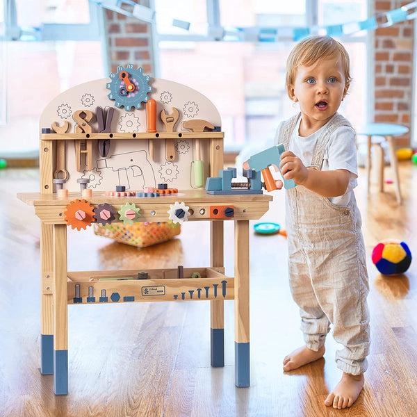 Child playing with a toy workbench in a bright room