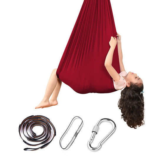 Red aerial yoga hammock with accessories on a white background