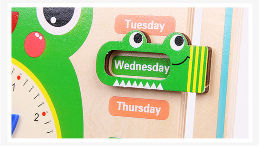 Children's educational calendar with a green dinosaur-shaped day marker on 'Wednesday'.