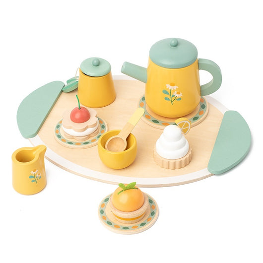 Toy tea set with cups, saucers, and cakes on a white background