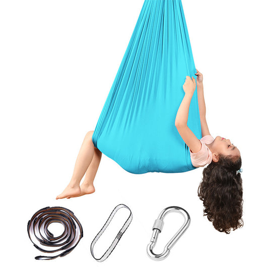 Person using a blue aerial yoga swing with straps and carabiner on a white background
