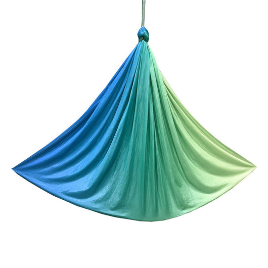 Blue and green hammock hanging against a white background