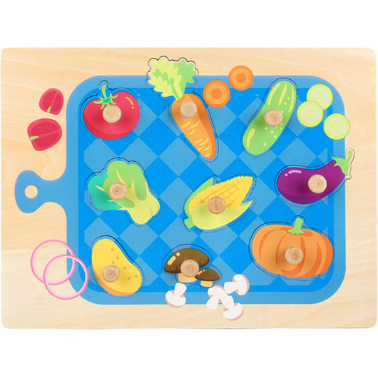 Wooden puzzle board with colorful vegetable-shaped pieces on a blue background
