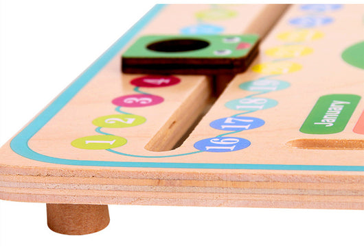 Wooden educational board with numbers, letters, and dates on a white background