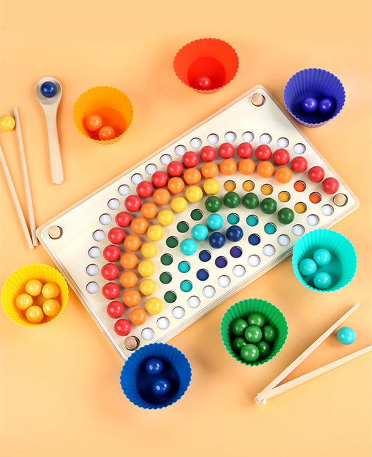Colorful dot game with rainbow pattern on a beige background