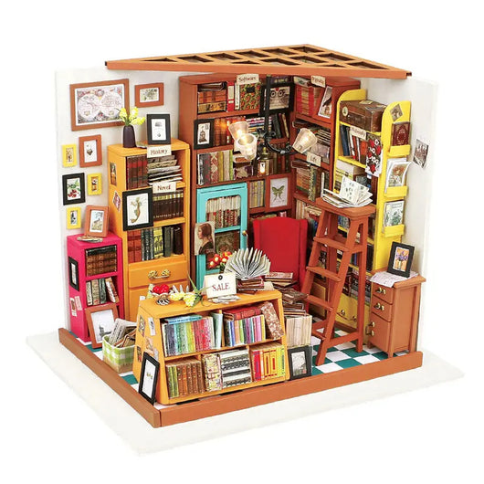Miniature model of a bookshelf filled with books and decorations on a white background