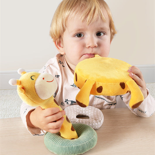 Child holding a yellow plush toy with a banana-shaped object