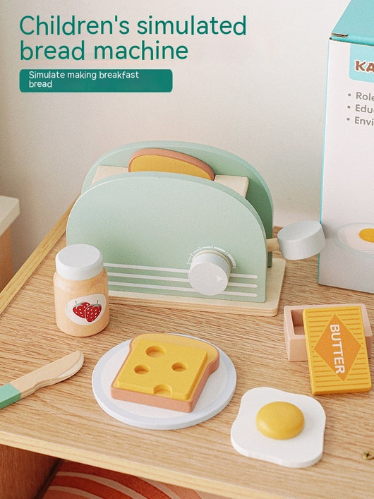 Children's simulated bread machine set on a wooden surface with a box in the background.