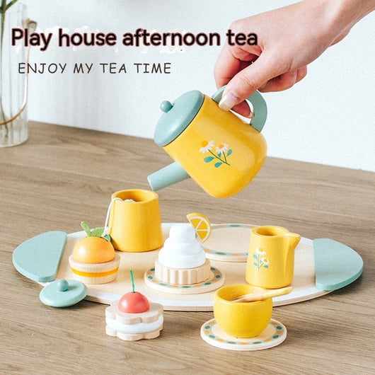 Playhouse afternoon tea set with a yellow teapot on a wooden surface.