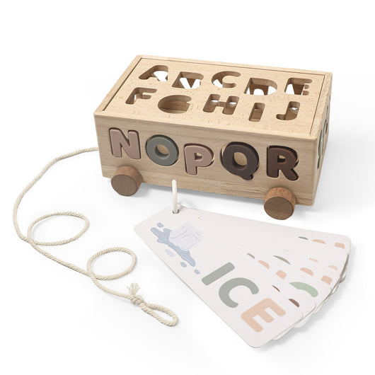 Wooden toy with letters and a pull string, accompanied by a mat with letter print on a white background.