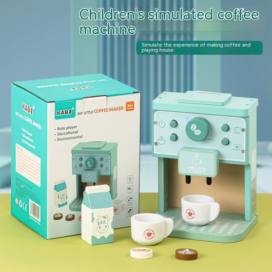 Children's simulated coffee machine with packaging on a green surface