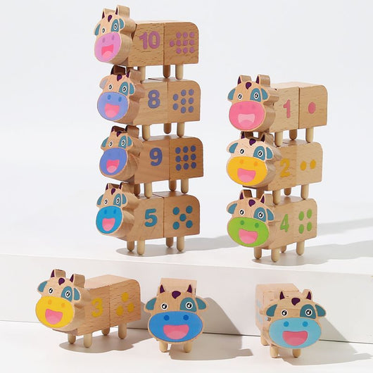 Wooden toys shaped like animals with number faces on a white background