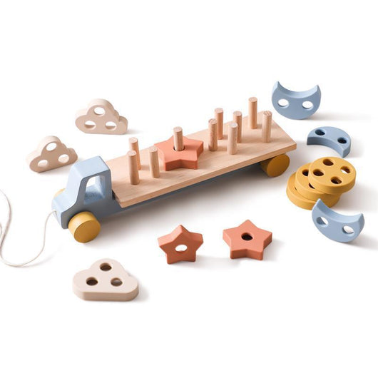Wooden toy with shapes and a truck on a white background