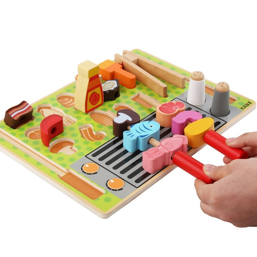 Colorful wooden hammering toy with various shapes and a hand using a red hammer.