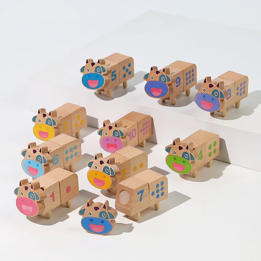 Set of wooden cow-shaped blocks with colorful faces on a white background