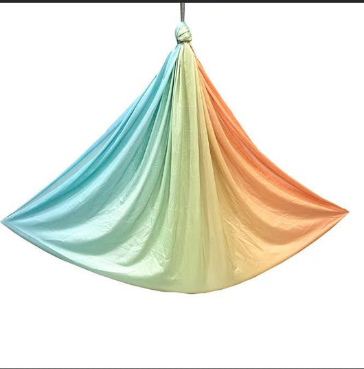Colorful hammock with a gradient from blue to orange on a white background