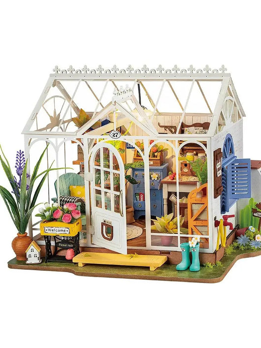 Detailed miniature dollhouse with interior furniture and decor on a white background
