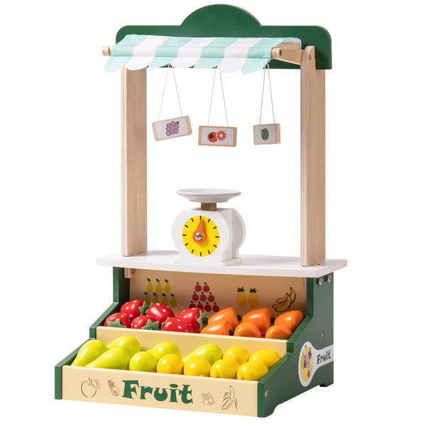 Wooden toy fruit stand with fruits and a scale on a white background