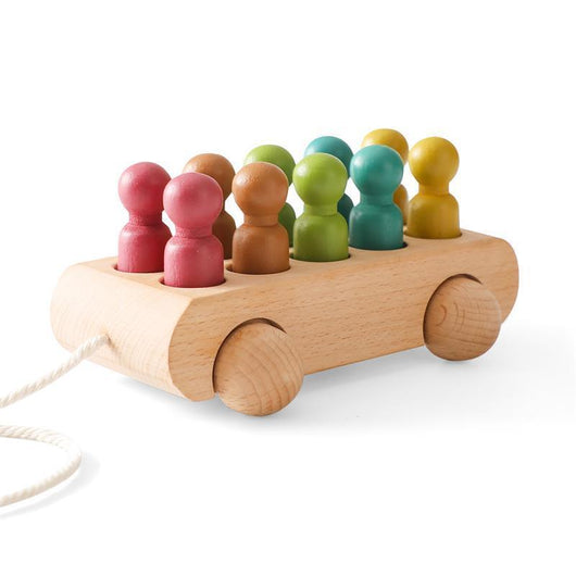 Wooden toy car with colorful peg people on a white background