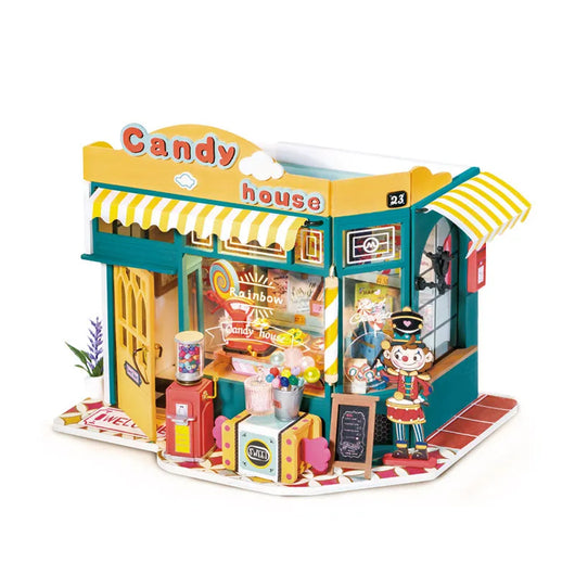 Toy candy store model with colorful facade and detailed interior on a white background