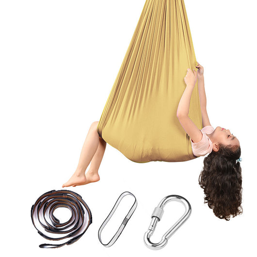 Person using a yellow aerial yoga hammock with accessories on a white background