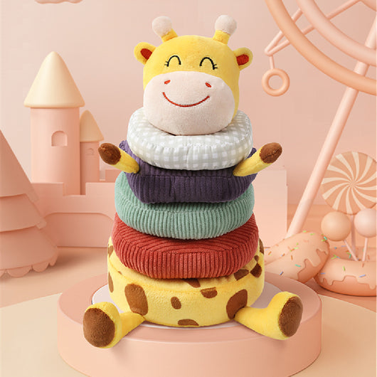Stackable toy giraffe with colorful layers on a pink background