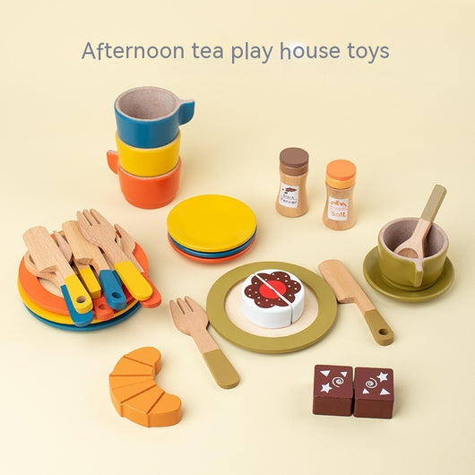 Colorful toy tea set with cups, plates, utensils, and a cake on a beige background.