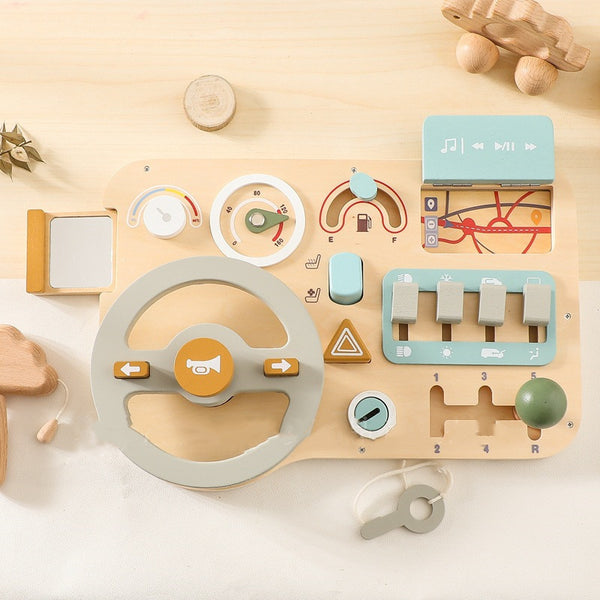 Wooden toy control panel with various buttons and levers on a light wooden surface.