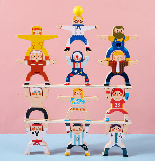 Set of wooden toy figures on a pink and blue gradient background